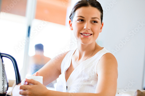 Happy young woman with cup of tea or coffee at home Free Download Happy young woman with cup of tea or coffee at home - GFXLoad