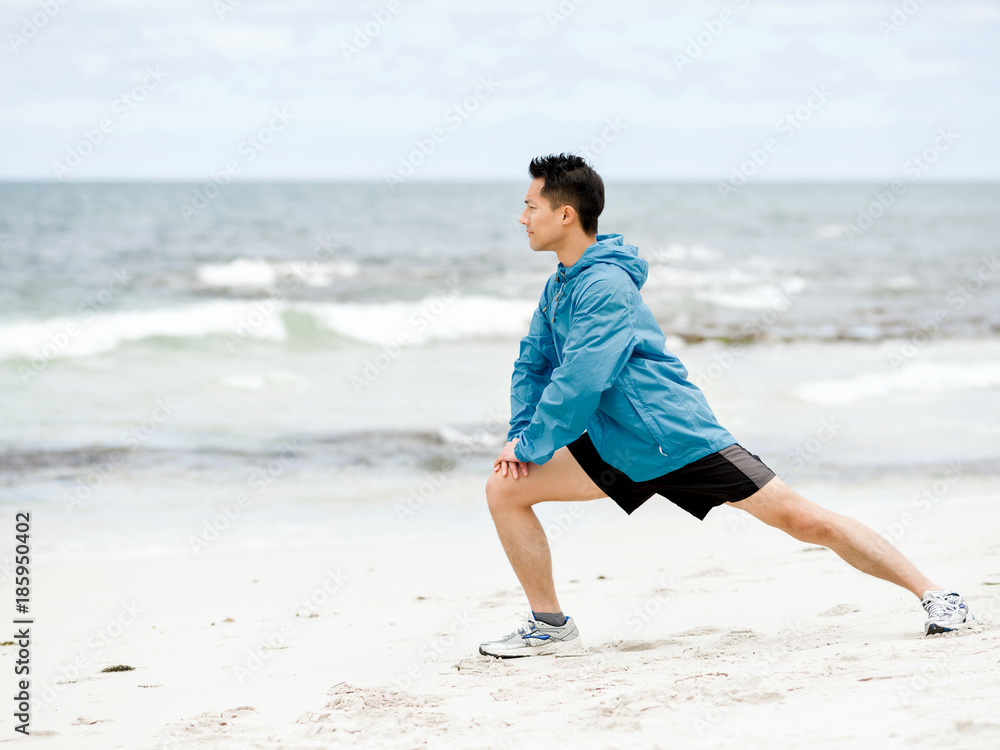 Young man doing exercise at the beach Young man doing exercise at the beach