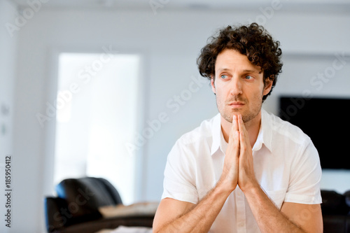 Portrait of a smart young man standing in kitchen photo