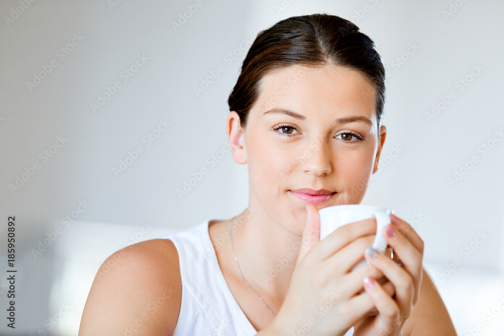 Happy young woman with cup of tea or coffee at home Happy young woman with cup of tea or coffee at home