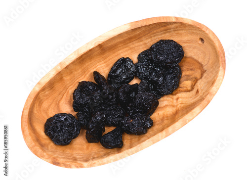 Organic unsweetened and unsulfured bing dried cherries in wooden bowl isolated on white background