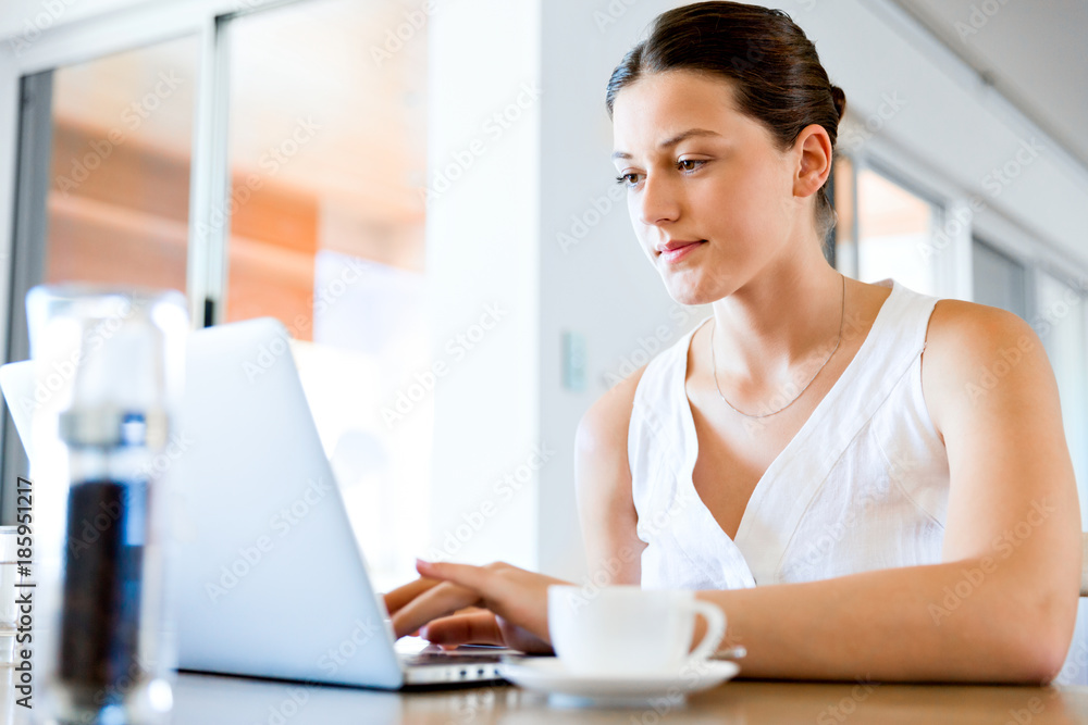 Young beautiful woman working on her laptop Young beautiful woman working on her laptop