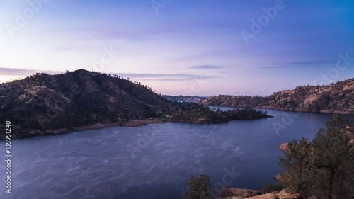 Timelapse of sunrise over Millerton Lake as mist and fog burns away in the heat photo