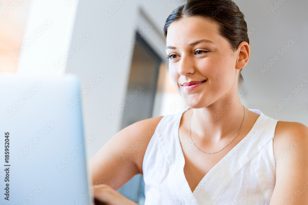 Young beautiful woman working on her laptop Young beautiful woman working on her laptop