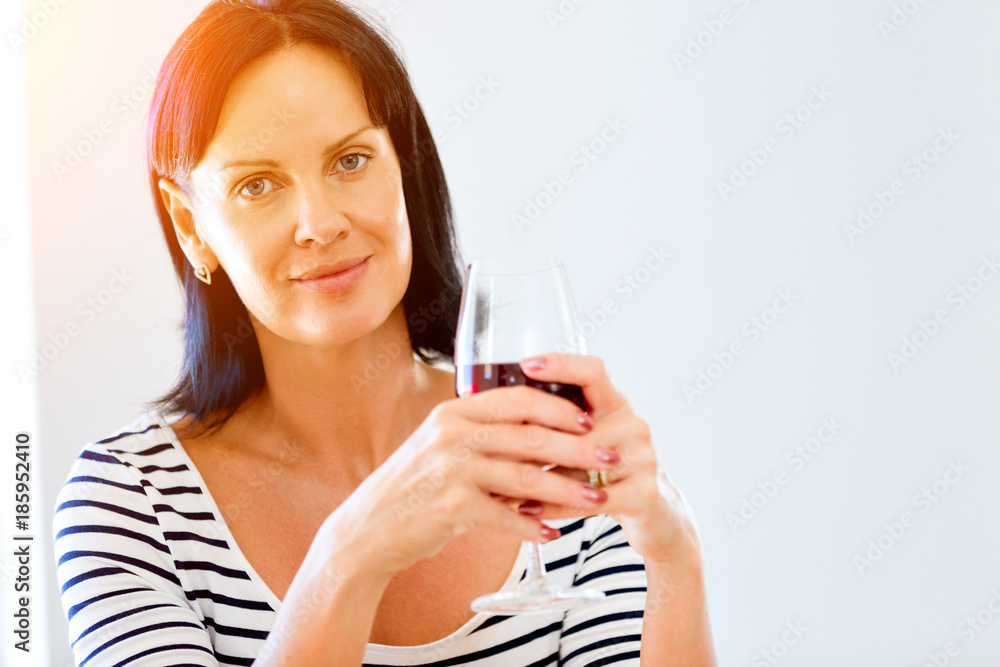 Beautiful young woman holding glass with red wine Beautiful young woman holding glass with red wine
