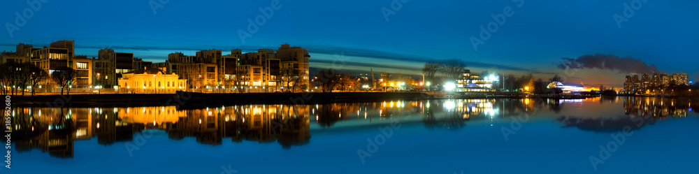 night panoramic photo of the river and the city - the Neva river and St. Petersburg, Russian Federation