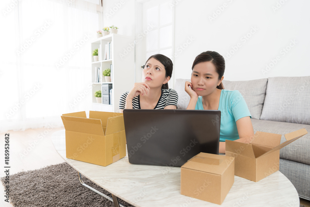 young lovely girls sitting on living room floor young lovely girls sitting on living room floor