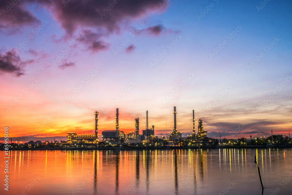Oil and gas industry - refinery at sunrise - factory - petrochemical plant with reflection over the river