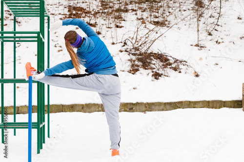Woman wearing sportswear urban exercising outside during winter © Voyagerix