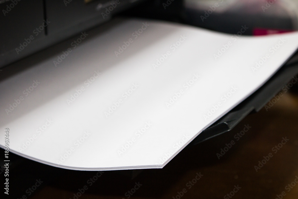 close-up white paper sheets on the printer in office. close-up white paper sheets on the printer in office.