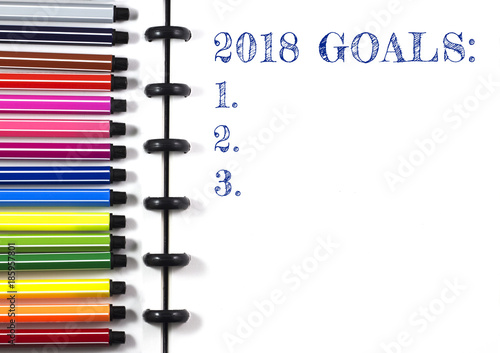 2018 Goals text on white sketchbook with color pen, top view