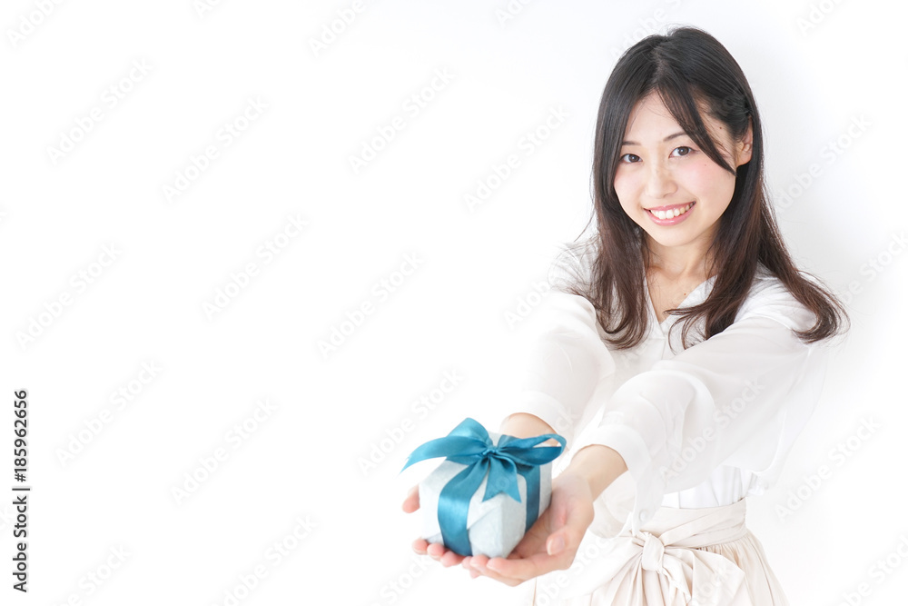Young woman giving a present to someone Young woman giving a present to someone
