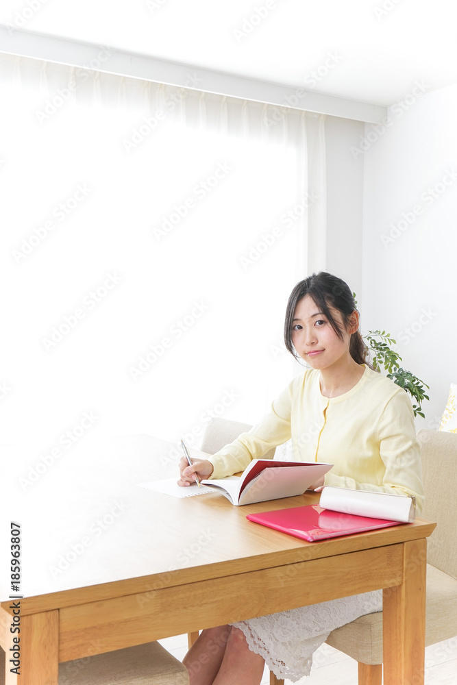 Female student studying for an entrance exam at home Female student studying for an entrance exam at home