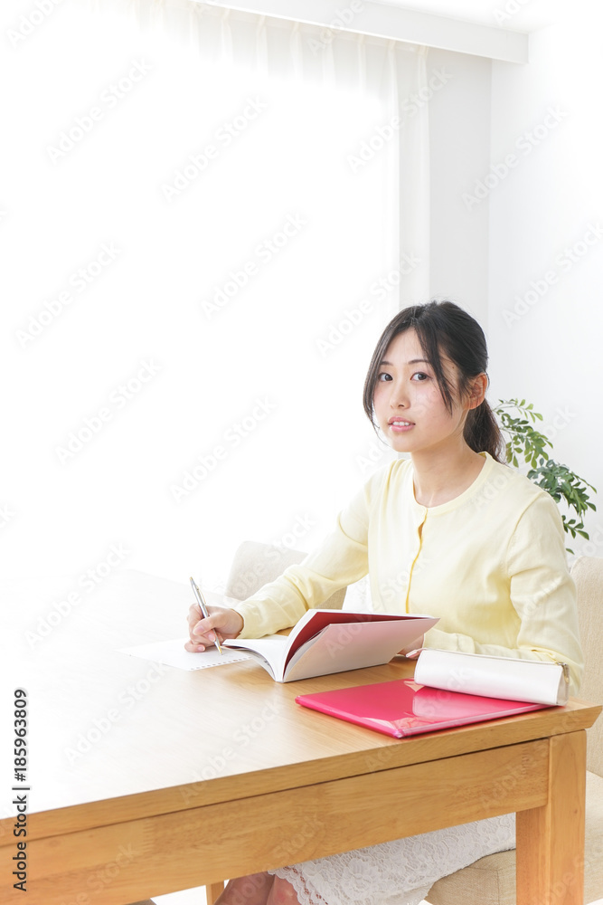 Female student studying for an entrance exam at home Female student studying for an entrance exam at home