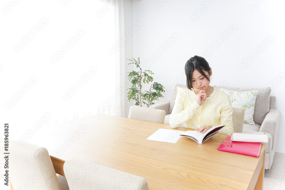 Female student studying for an entrance exam at home Female student studying for an entrance exam at home