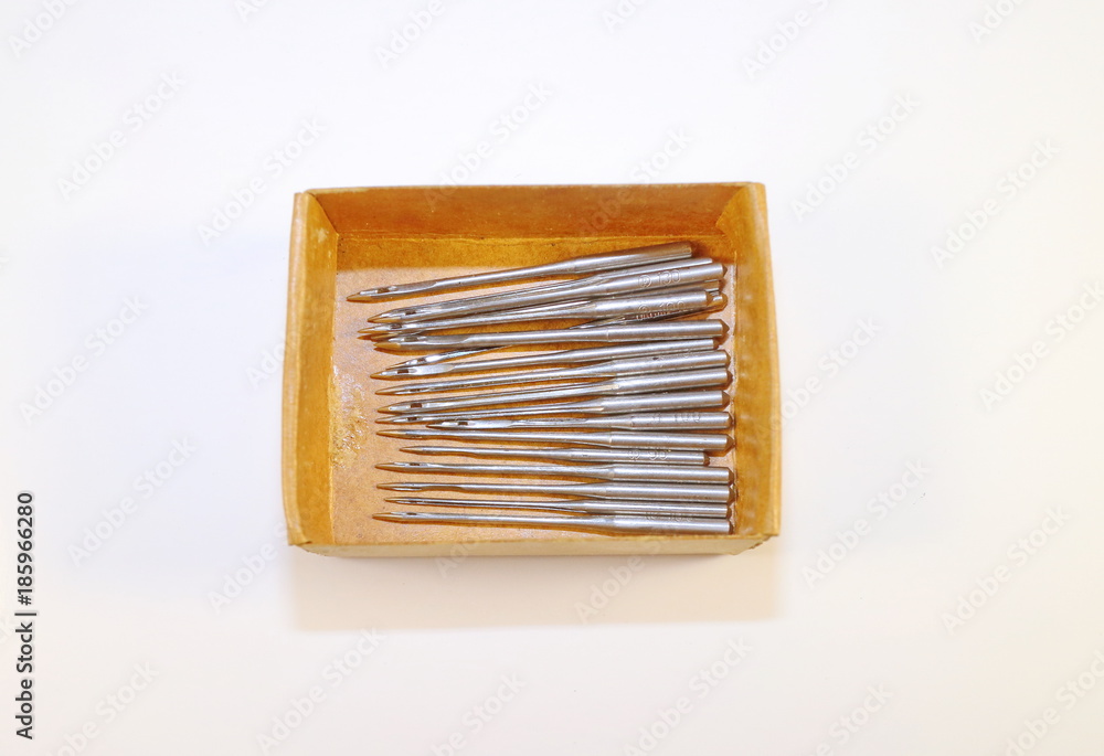 Needles for a sewing machine in a box on a white background Needles for a sewing machine in a box on a white background