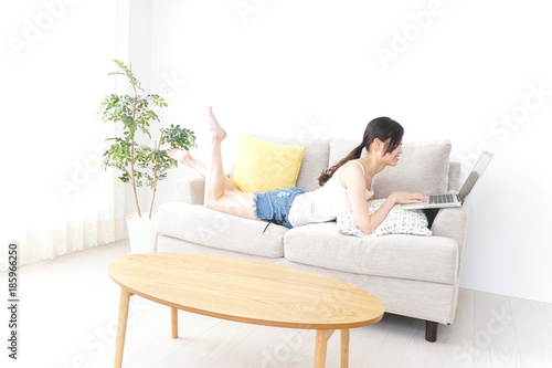 Young woman using laptop in room