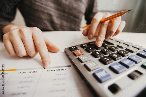 Photos Closeup of Accountant Hands Counting on Calculator