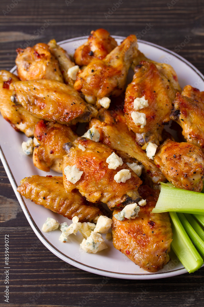 Chicken wings buffalo with blue cheese and celery sticks, vertical Chicken wings buffalo with blue cheese and celery sticks, vertical