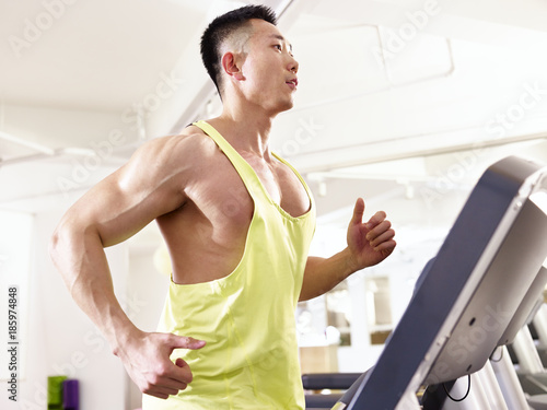 asian bodybuilder running on treadmill