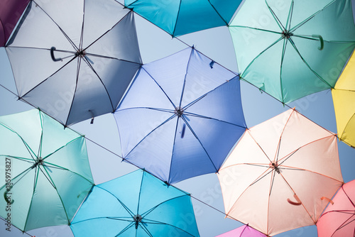 Abstract background of coloful umbrellas in pastel style