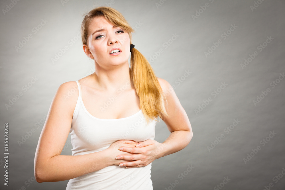Woman suffering from sharp chest pain Woman suffering from sharp chest pain