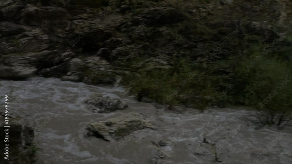 Muddy stream of water in a mountain river. Muddy stream of water in a mountain river.