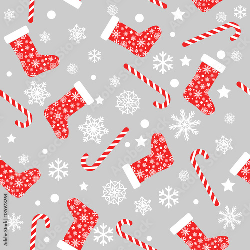 Seamless vector pattern with red and white christmas stocking socks, candy canes and snowflakes