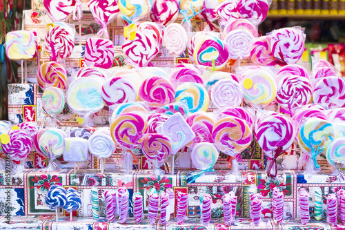 Colorful lollipops on stick for sale in shop window