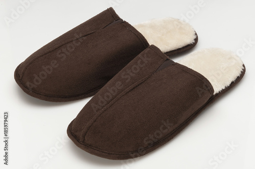 Pair of brown slippers on white background