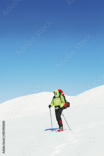 Winter hike in the mountains with a backpack and tent.