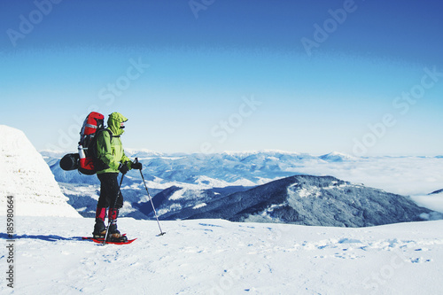 Winter hike in the mountains with a backpack and tent.