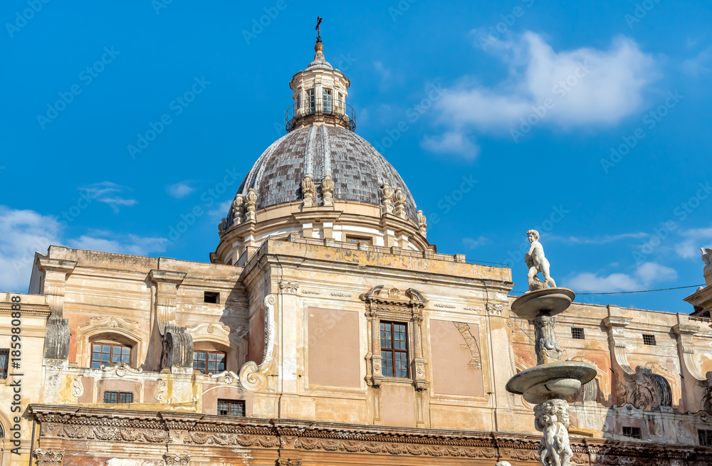 View of Santa Caterina church dome with statue of the Pretoria fountain ahead in Palermo, Sicily, Italy