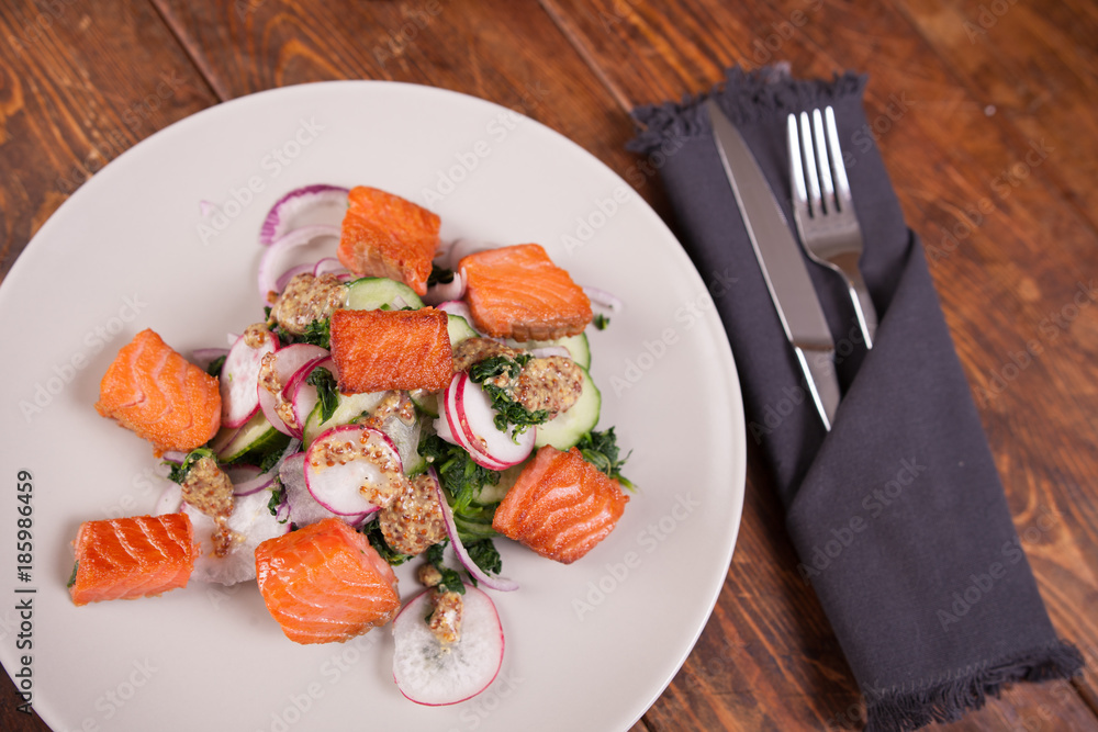 Salad with grilled salmon and  radish 