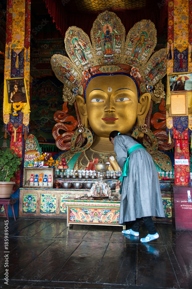 Woman praying in front of the Maitreya Buddha
