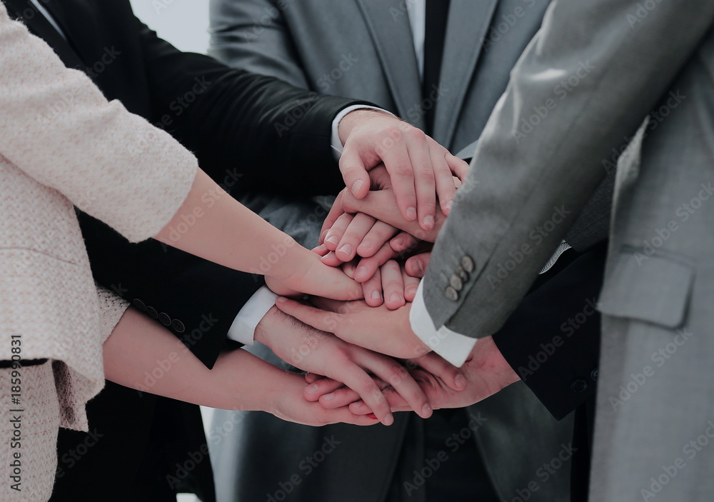 success concept collaboration: a friendly business team put thei success concept collaboration: a friendly business team put thei