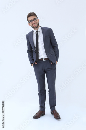 Young businessman standing with hands in pockets. © ASDF
