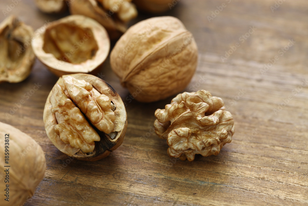 walnuts, kernel and shell on wooden background walnuts, kernel and shell on wooden background