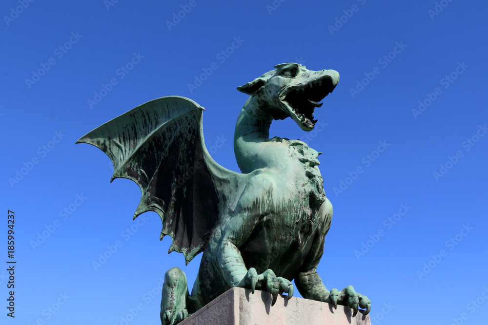 Dragon sculpture on The Dragon Bridge - historical landmark in Ljubljana, Slovenia. 

