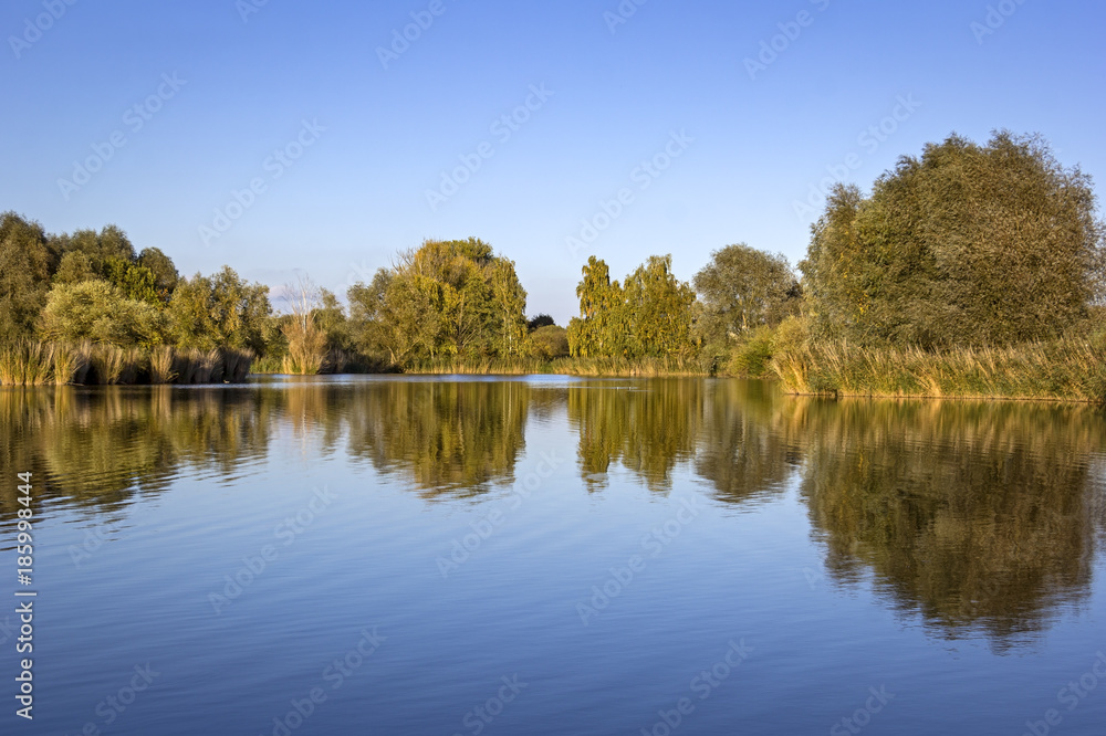 View of a small lake on a windless evening