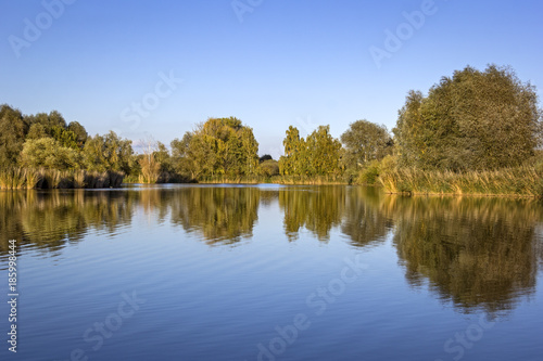 View of a small lake on a windless evening