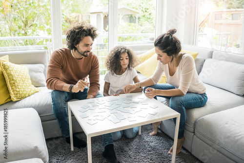 Family sitting on couch , playing memory game