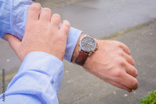 Men looking at wrist watch