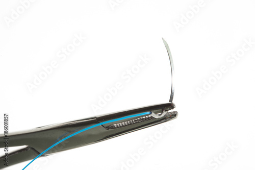 NEEDLE HOLDER AND SUTURE