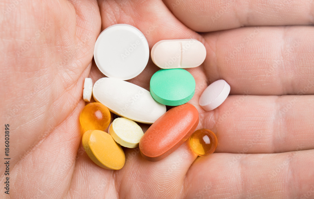 daily dose of pills on the human hand daily dose of pills on the human hand