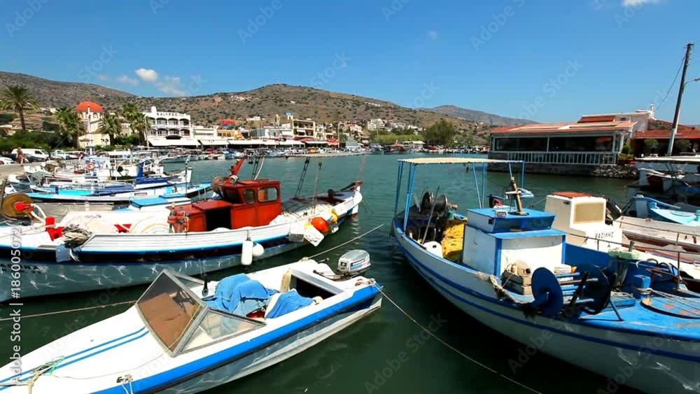 Crete Greece. Beautiful sea coast against the background of mountains. Ships and boats in the harbor. Crete Greece. Beautiful sea coast against the background of mountains. Ships and boats in the harbor.