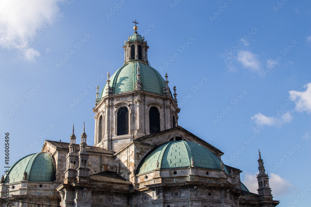 External view of the domes and spires of the Duomo of Como with blue domes. Late gothic architecture in northern Italy