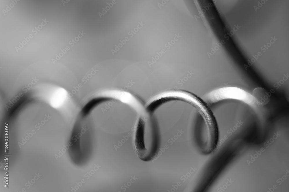 Metal spring device macro, soft focus, black and white photo Metal spring device macro, soft focus, black and white photo
