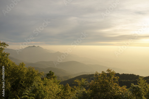 Beautiful mountain landscape, with mountain peaks covered with forest and a cloudy sky