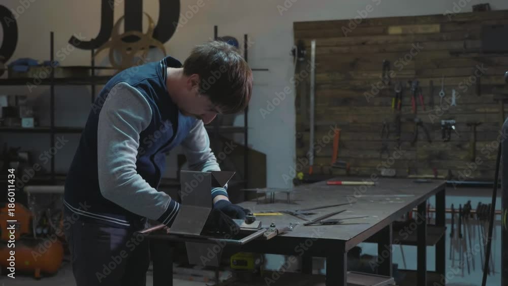 Blacksmith working with metal decorative detail at his workshop Blacksmith working with metal decorative detail at his workshop